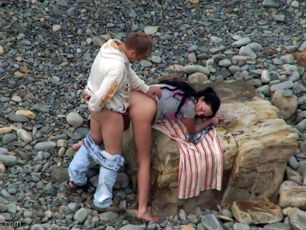 Adorable looking duo having intercourse on the remote beach