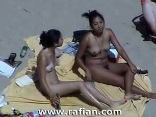 African and milky femmes sunbathing on naked beach